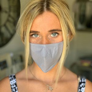 Woman wearing reusable copper infused face mask front profile