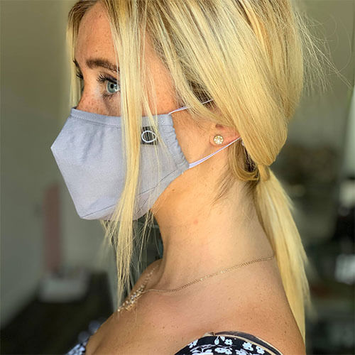 Woman wearing reusable copper infused face mask side profile